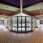 View of forked hallways with wooden flooring. - ceiling, daylighting, floor, flooring, interior design, lobby, real estate, brown, gray