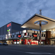 Exterior view of mall at dusk. - Exterior architecture, building, commercial building, corporate headquarters, facade, mixed use, real estate, residential area, sky, structure, teal, blue