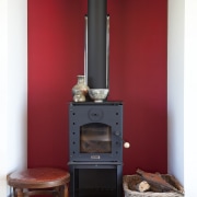 Chimney with red feature wall and low wooden fireplace, hearth, home appliance, kitchen stove, stove, wood burning stove, red, white