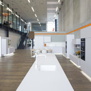 Showroom with white cabinetry and wooden flooring. daylighting, interior design, product design, gray, white