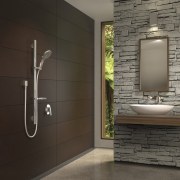 Bathroom with brown wall and stone wall feature. bathroom, floor, flooring, home, interior design, room, tile, wall, black, gray