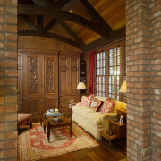 brick walls, exposed varnished rafters, lounge area, dark beam, ceiling, floor, flooring, hardwood, home, interior design, living room, log cabin, room, wall, window, wood, wood flooring, brown