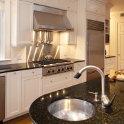 circular kitchen, white cabinets, dark benchtops, wooden floors. cabinetry, countertop, cuisine classique, floor, home, interior design, kitchen, room, brown, gray, orange