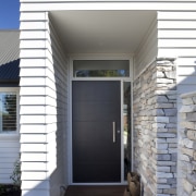 The Palliside weatherboard cladding system provides a clean, architecture, door, facade, home, house, real estate, siding, gray, white