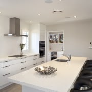 Kitchen with white island, white cabinetry, stainless hood countertop, interior design, kitchen, real estate, room, gray