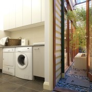 Laundry with grey tiled floor and white cabinets. home, home appliance, laundry, laundry room, major appliance, property, real estate, room, washing machine, white, brown