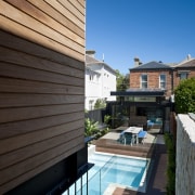 View down stairs to pool and patio area. apartment, architecture, backyard, balcony, condominium, daylighting, estate, facade, home, house, outdoor structure, property, real estate, residential area, roof, siding, swimming pool, villa, black