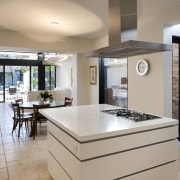 Kitchen with tiled flooring and white island. - countertop, interior design, kitchen, real estate, room, gray
