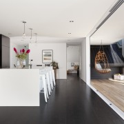 Seen here is a home designed by Chris floor, flooring, house, interior design, kitchen, real estate, room, white, black