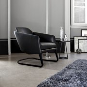Black contemporary seat on grey flooring with grey chair, club chair, couch, floor, flooring, furniture, hardwood, interior design, laminate flooring, living room, loveseat, product, product design, recliner, table, wood, wood flooring, gray