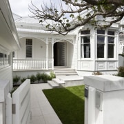 Path leading up to house with white exterior architecture, backyard, courtyard, estate, facade, home, house, mansion, neighbourhood, outdoor structure, porch, property, real estate, residential area, siding, walkway, window, yard, white, gray