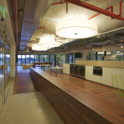 Interior with long wooden divider and exposed red interior design, leisure centre, brown