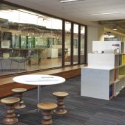 Interior with low seats and round table. - floor, flooring, brown