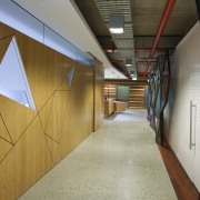 Hallway with triange cutout design on walls. - architecture, ceiling, daylighting, floor, wood, brown, gray