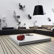 Lounge with striped flooring, black couch and contemporary angle, coffee table, couch, floor, furniture, interior design, living room, product, product design, table, white