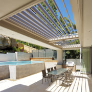 Patio and pool area with light toned paving. architecture, daylighting, estate, house, interior design, real estate, roof, window, brown