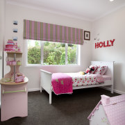 Child's room with grey carpet, pink bedding and bed, bed frame, bed sheet, bedding, bedroom, ceiling, furniture, home, interior design, pink, product, real estate, room, textile, gray