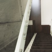 View down carpeted stairs. - View down carpeted floor, flooring, handrail, property, stairs, wall, wood, gray, white, black