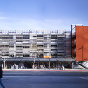 View of parking garage from street level. - architecture, building, city, commercial building, condominium, corporate headquarters, daytime, facade, headquarters, metropolis, metropolitan area, mixed use, neighbourhood, residential area, sky, structure, tower block, urban area, teal, blue