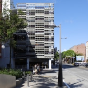 Parking garage from street level. - Parking garage apartment, architecture, building, city, commercial building, condominium, corporate headquarters, daytime, downtown, facade, headquarters, metropolis, metropolitan area, mixed use, neighbourhood, real estate, residential area, sky, skyscraper, tower block, urban area, urban design, teal