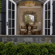 This home's interior was designed by Bruce Kading. architecture, door, facade, home, house, outdoor structure, porch, window, black, brown