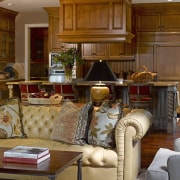 This home's interior was designed by Bruce Kading. furniture, home, house, interior design, living room, lobby, room, wood, brown