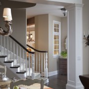 White walls and crown mouldings. Neutral furniture colours. architecture, ceiling, dining room, floor, furniture, home, interior design, living room, room, table, wall, window, wood, gray