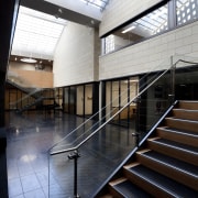 Stairs with black tread and light toned stone architecture, building, daylighting, glass, handrail, interior design, line, lobby, stairs, structure, tourist attraction, window, wood, black, white