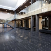 Interior with grey tiles and stairs. - Interior apartment, architecture, daylighting, floor, flooring, interior design, lobby, real estate, tile, black, white