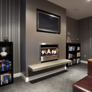 tv screen above fireplace in dark wallpapered room fireplace, floor, flooring, furniture, hearth, interior design, living room, room, gray, black