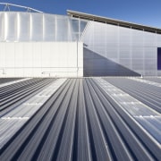 View of grey roof and grey building. - architecture, building, daylighting, energy, facade, fixed link, infrastructure, line, roof, sky, sport venue, structure, gray