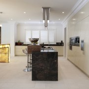 kitchen with dark rectangular island and long honey countertop, floor, flooring, interior design, kitchen, real estate, room, gray