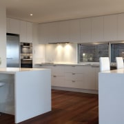 Contemporary kitchen with wooden flooring, white drawers and architecture, cabinetry, countertop, cuisine classique, floor, interior design, kitchen, real estate, gray