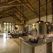 Rustic house modelled on French barn. Interiors feature beam, ceiling, countertop, interior design, kitchen, brown