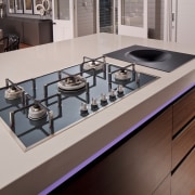 Contemporary kitchen with cooktop and inbuilt wok. countertop, furniture, kitchen, kitchen stove, product design, sink, gray, red