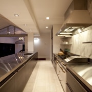 kitchen, stainless steel, galley style, streamlined apartment, architecture, cabinetry, ceiling, countertop, cuisine classique, daylighting, floor, flooring, house, interior design, kitchen, room, under cabinet lighting, orange, brown