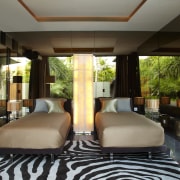 Twin beds in this bedroom are positioned between interior design, black