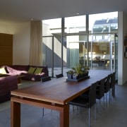 In this inward-looking home, the living spaces, kitchen architecture, furniture, house, interior design, living room, real estate, room, table, window, black, gray