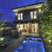 Backside of house with pool. - Backside of apartment, architecture, backyard, cottage, courtyard, estate, facade, family car, home, house, landscape lighting, lighting, mansion, property, real estate, reflection, residential area, sky, swimming pool, villa, window, blue