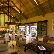 Rustic house modelled on French barn. Interiors feature interior design, living room, lobby, real estate, brown