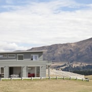 front of house exterior, two storey, otago hills architecture, cloud, cottage, elevation, farmhouse, highland, home, house, landscape, mountain, property, real estate, residential area, roof, rural area, sky, white