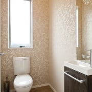 bathroom with toilet and vanity, peach wallpaper - bathroom, bathroom accessory, bathroom sink, bidet, ceramic, floor, flooring, home, interior design, plumbing fixture, room, sink, tile, toilet, toilet seat, wall, white, orange, brown