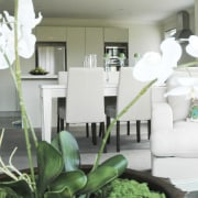 white flowers, dining table beyond. all white - dining room, floristry, flower, furniture, green, home, house, interior design, living room, plant, room, white