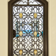 This home was designed by Geoffrey Bradfield. Here glass, iron, stained glass, window, yellow, brown