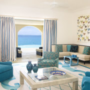This home was designed by Geoffrey Bradfield. Here blue, furniture, interior design, living room, room, table, white