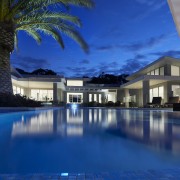 This home's landscape was designed by Dean Herald architecture, condominium, estate, evening, home, hotel, house, leisure, lighting, mansion, property, real estate, reflection, resort, resort town, sky, swimming pool, villa, water, blue