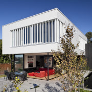A white box or cloud floats above the architecture, building, facade, home, house, real estate, blue