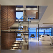 This is a home that was designed by architecture, ceiling, floor, interior design, lobby, loft, brown, gray