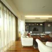 Living area with white furnature and polished floors ceiling, floor, flooring, hardwood, interior design, living room, real estate, room, wall, wood flooring, orange, brown, yellow