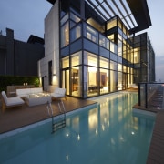 This two-storey penthouse in a near-new building in apartment, architecture, building, condominium, daylighting, estate, facade, home, house, lighting, property, real estate, reflection, swimming pool, villa, window, teal, black